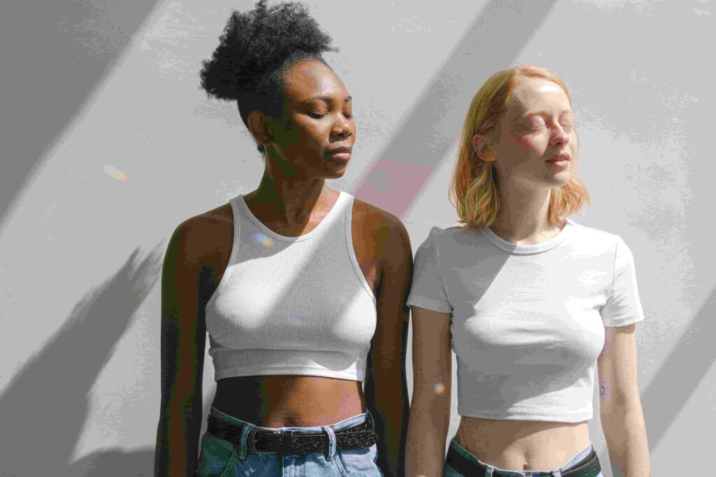Two women standing in sunlight representing natural vitamin D exposure for hormonal balance and PCOS health